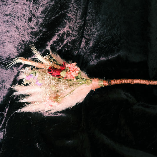 Broom stick crafted with home grown dried florals. Used to adorn the walls or as an altar tool.